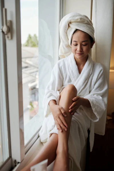 Smiling Young Woman Soft Bathrobe Sitting Window Sill Applying Firming — Stock Photo, Image