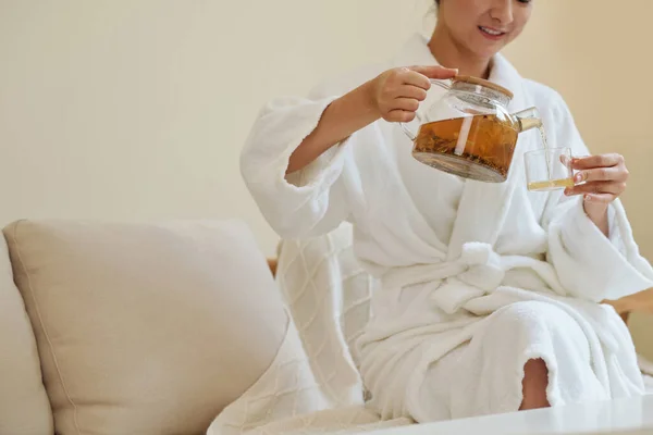 Smiling Young Woman Bathrobe Pouring Herself Cup Herbal Tea Procedure — Stock Photo, Image