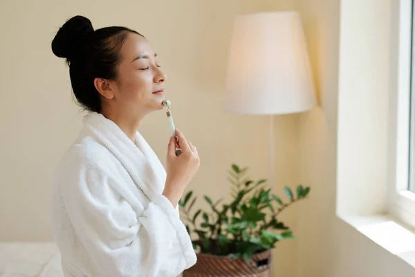 Smiling Young Woman Bathrobe Massaging Face Shape Roller Stimulate Blood — Stock Photo, Image