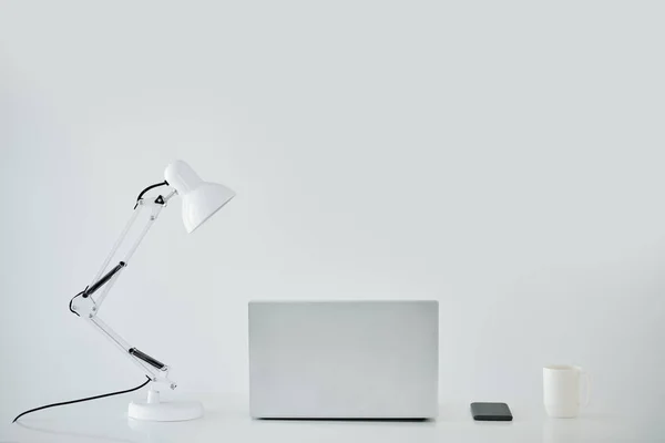 Bilgisayarı Lambayı Akıllı Telefonu Kupayı Beyaz Ofis Masasında Açtım — Stok fotoğraf