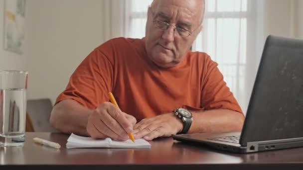 Gözlüklü Üst Düzey Bir Adamın Masada Oturup Dizüstü Bilgisayarda Yazarken — Stok video