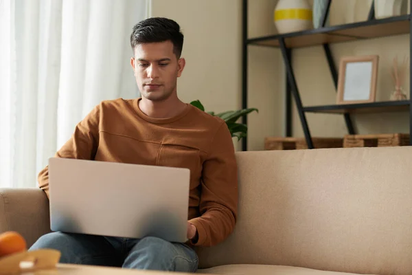 Serious Young Man Working Laptop Watching Online Webinar Sitting Sofa — Stock Photo, Image