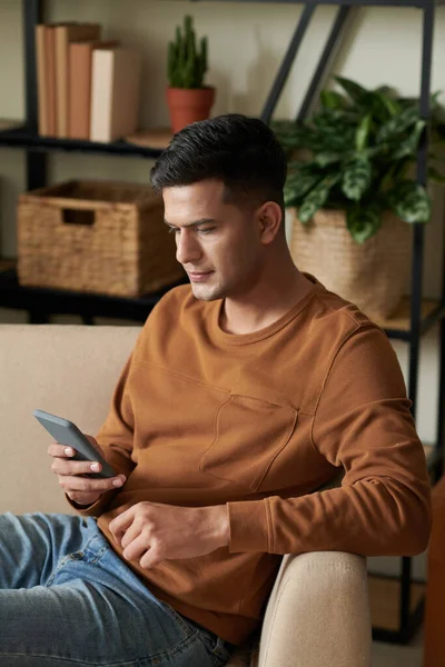 Serious Young Man Resting Sofa Home Reading Post Article Social — Stock Photo, Image