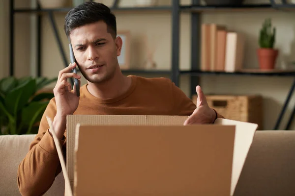 Angry Young Man Calling Delivery Service Receiving Wrong Package — Stock Photo, Image