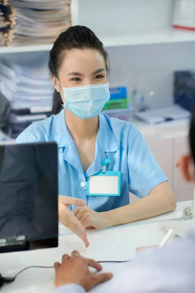 Positive Young Asian Medical Nurse Talking Patient Clinic Reception — Stock Photo, Image