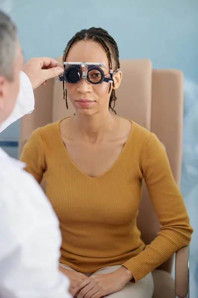 治験用レンズフレームの患者の一つの目をカバーし チャート上の文字を読むように頼む眼科医 — ストック写真