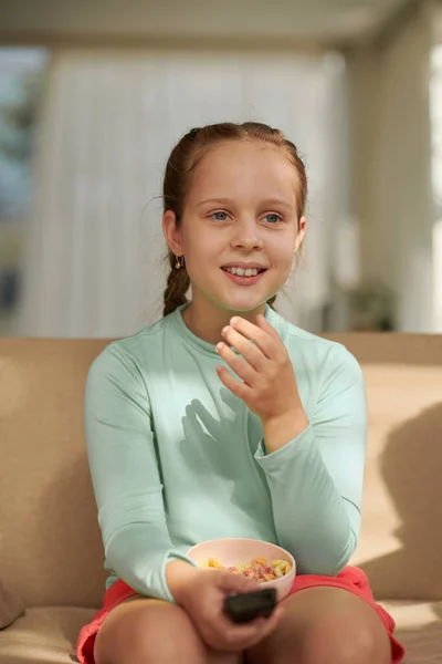 Ευτυχισμένο Κορίτσι Τρώει Γλυκά Σνακ Και Βλέποντας Τηλεόραση Στο Σπίτι — Φωτογραφία Αρχείου