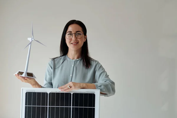 Uśmiechnięta Kobieta Prezentująca Panel Słoneczny Model Turbiny Wiatrowej Koncepcja Zielonej — Zdjęcie stockowe
