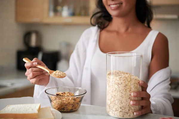 Young Woman Adding Spoon Oat Flakes Bowl Making Tasty Healthy — Stock Photo, Image