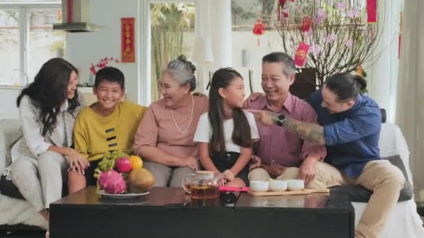 Glad Flergenerationsfamilj Asiatisk Sitter Soffan Vardagsrummet Dekorerad För Tet Chatta — Stockvideo