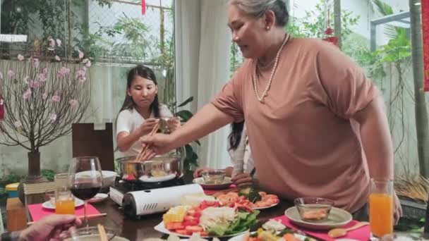 Zoom Shot Senior Grandmother Serving Corn Hot Pot Family While — Stock Video