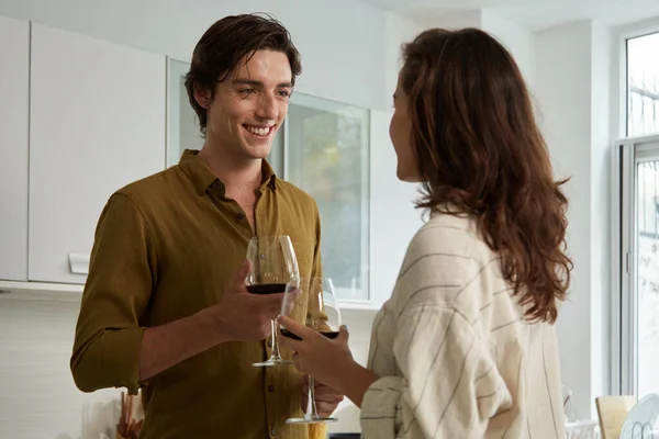Χαμογελώντας Νεαρός Ερωτευμένος Κοιτάζοντας Φίλη Όταν Πίνουν Κρασί Στην Κουζίνα — Φωτογραφία Αρχείου