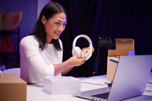 stock image Techno blogger filming review of new headphones for her channel