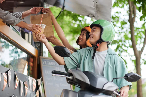 Glada Unga Asiatiska Par Skyddande Hjälmar Tar Paperbag Med Snabbmat — Stockfoto