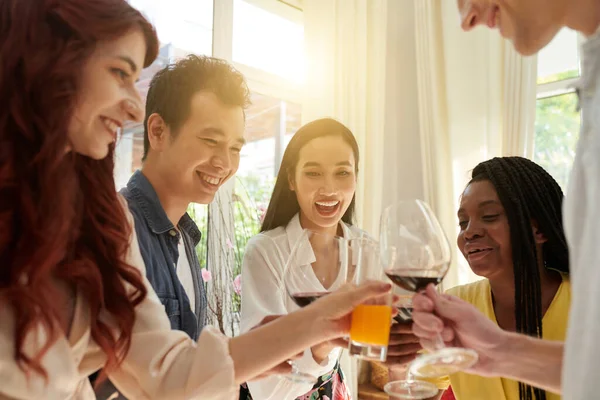 在家庭派对上 快乐的年轻跨文化朋友们在镜头前与他们的饮料叮当作响 一边欢度庆祝 一边玩乐 — 图库照片