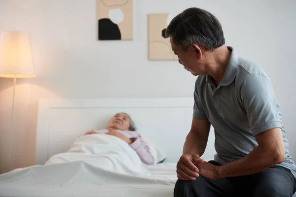 Yaşlı Adam Hasta Karısının Yatağında Yatıyor — Stok fotoğraf