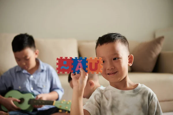 Улыбающийся Маленький Вьетнамский Мальчик Играющий Алфавитной Головоломкой Дома — стоковое фото