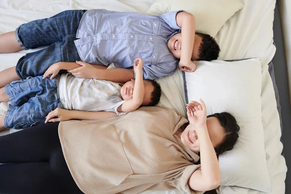 Mère Souriante Deux Fils Couchés Sur Lit Couvrant Les Yeux — Photo