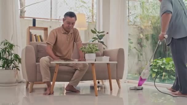 Pár Seniorů Uklízejí Obývák Vysávají Podlahu Utírají Prach Stolu — Stock video