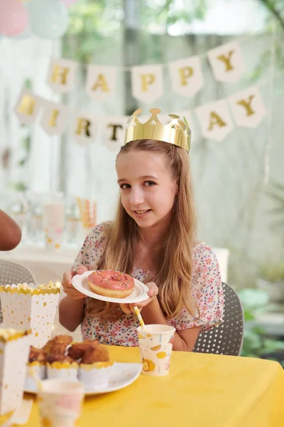 Portrait Smiling Birthday Girl Paper Crown Showing Glazed Doughnut — Stock Photo, Image