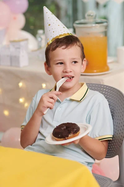 Portrait Cheerful Preteen Boy Eating Doughnut Chocolate Glaze Birthday Party — Stock Photo, Image