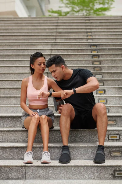 Fit Young Man Comparing Numbers His Girlfriends Fitness Trackers — Stock Photo, Image