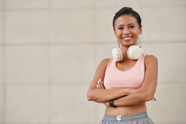 Portrait Smiling Jogger Sports Bra Headphones Crossing Arms Looking Camera — Stock Photo, Image