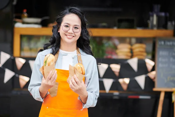 Portrait Smiling Street Food Truck Worker Holding Two Sandwiches — Stock Photo, Image