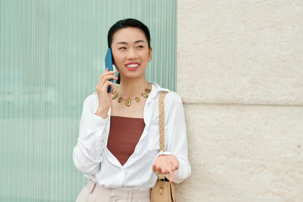 Portret Pogodnej Eleganckiej Bizneswoman Opierającej Się Ścianie Rozmawiającej Przez Telefon — Zdjęcie stockowe