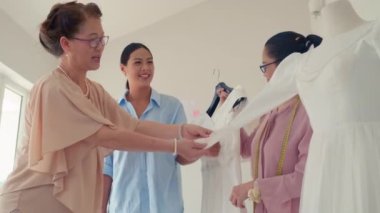 Anne ve kızının kuafördeki en iyi gelinliği seçtiği düşük açılı fotoğraf.