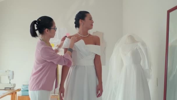 Середній Довгий Знімок Кравець Перевіряє Весільну Сукню Нареченій Примірці Ательє — стокове відео