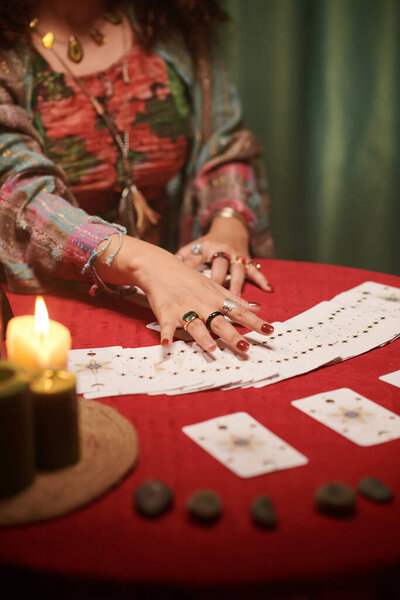 Hands of psychic reading tarot cards, seeing fortune