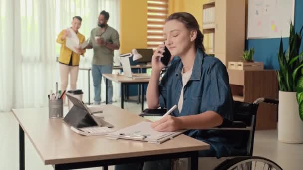Medelhög Bild Ung Kvinna Rullstol Pratar Smartphone När Sitter Kontoret — Stockvideo