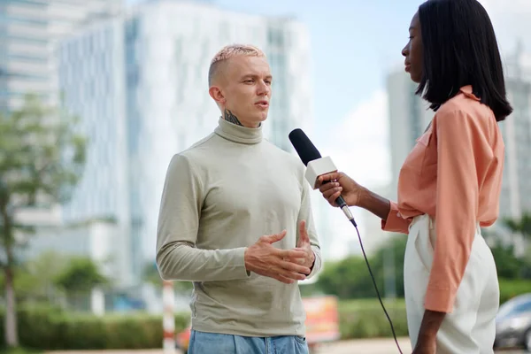 stock image Serious man giving interview to local channel journalist