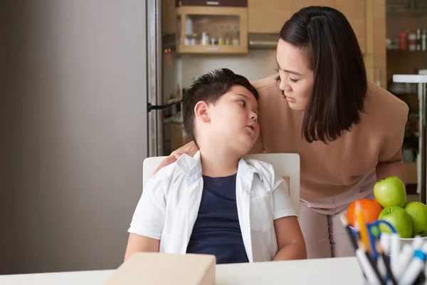 Tired boy complaining mother about difficult assignments