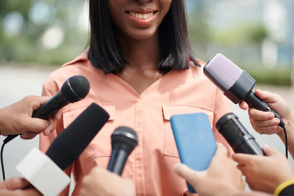 Cropped image of smiling Black female politician talking to press