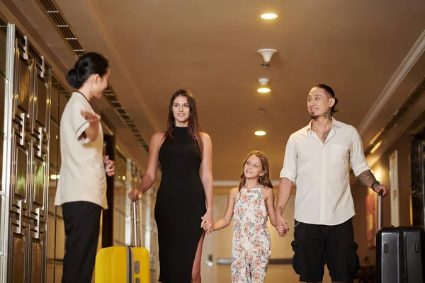 Hotel maid showing family way to their room