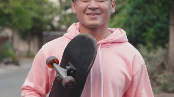 Γείρε Μέχρι Πορτρέτο Του Χαμογελαστού Ασιάτη Skateboarder Μπλε Μαλλιά Κοιτάζοντας — Αρχείο Βίντεο