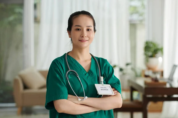 Portrait Smiling Vietnamese Social Worker Badge Uniform Standing Apartment Patient — Stock Photo, Image