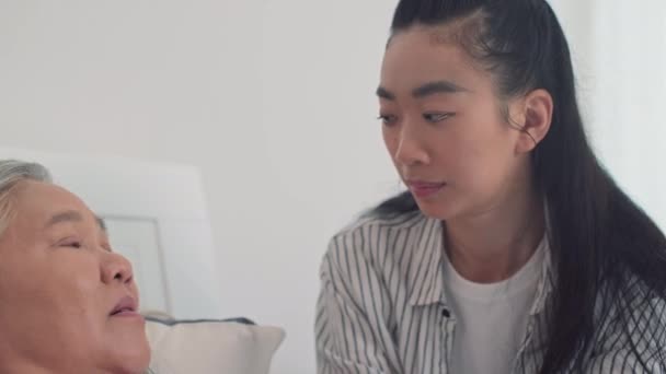 Junge Asiatin Hält Ihre Älteren Kranken Mütter Den Händen Während — Stockvideo