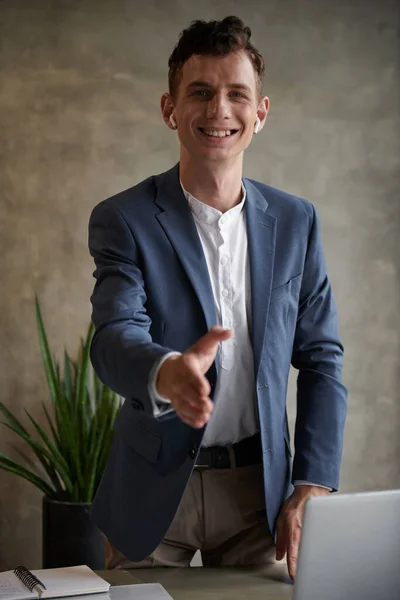 Smiling Young Businessman Outstretching Hand Handshake Looking Camera — Stock Photo, Image