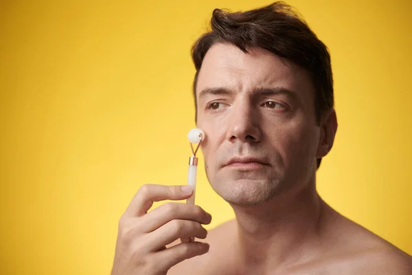 Portrait Mature Man Massaging Face Rose Quartz Roller Morning Shower — Stock Photo, Image