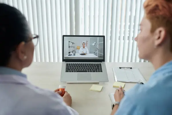 Medical Professionals Sitting Table Front Laptop Talking Colleague Online Video — Stock Photo, Image