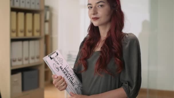 Kafkas Pozitif Kadın Pazarlamacının Sunum Için Kağıt Tutarken Kameraya Bakarken — Stok video