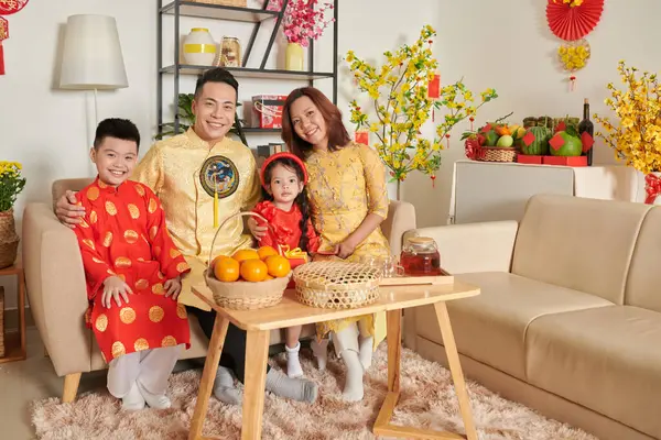 Happy family with two kids celebrating Lunar New Year at home