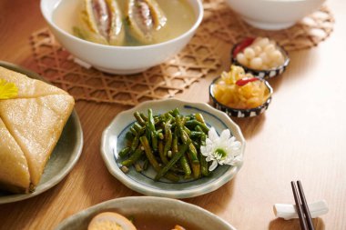 Vietnam usulü yeşil fasulyeler yemek masasında diğer mezelerin yanında.