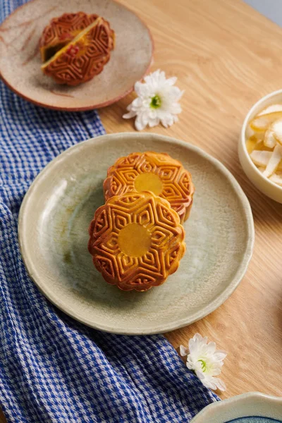 Traditional moon cakes with various fillings on table served for mid-autumn festival