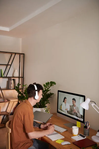 Young man attending online meeting eith colleagues when working from home