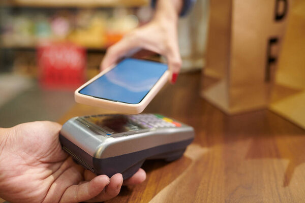 Closeup image of cashier accepting payment for clothes and shoes
