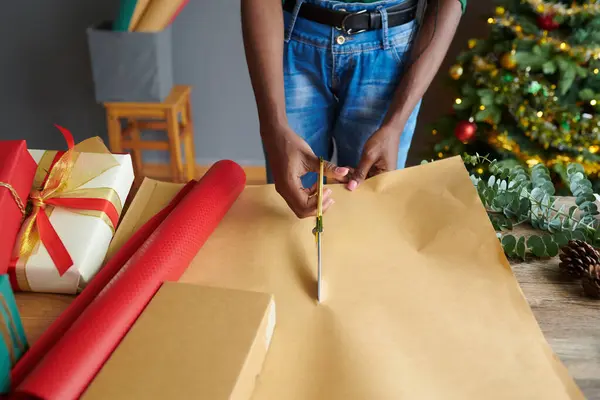 Process of cutting wrapping paper sheets for Christmas presents decoration
